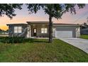 Charming single-story home featuring a manicured lawn, a two-car garage, and a welcoming front entrance at 2511 Avenue E Sw, Winter Haven, FL 33880