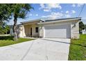 Well-kept single-story home with a two-car garage and a modern, neutral-toned exterior at 2511 Avenue E Sw, Winter Haven, FL 33880