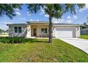 Inviting single-story home featuring a quaint entryway and an attached two-car garage at 2511 Avenue E Sw, Winter Haven, FL 33880