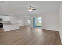 Spacious living area featuring wood-look flooring, a ceiling fan, and sliding glass doors to the backyard at 16913 Sw 39Th Cir, Ocala, FL 34473