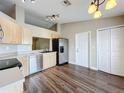 Bright kitchen with stainless steel appliances, sleek countertops, and wood look flooring at 7713 Manor Dr, Lakeland, FL 33810