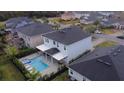 Aerial view of house with pool and spa; located in a quiet residential neighborhood at 116 Prestwick Grande Dr, Daytona Beach, FL 32124