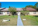 Front view of a condo with a landscaped yard and walkway at 3017 Jon Jon Ct, Orlando, FL 32822