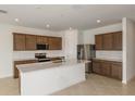 Spacious kitchen with wooden cabinetry, quartz countertops, stainless steel appliances, and an island at 4432 Sw 84Th Street Rd, Ocala, FL 34476