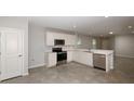 Kitchen featuring stainless steel appliances and white cabinetry at 5414 Sw 85Th Avenue Rd, Ocala, FL 34481