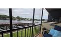 Enjoy water views from this screened balcony with comfy seating at 1640 Juno Trl # 202E, Astor, FL 32102