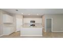 Modern kitchen featuring island, stainless steel appliances, and white cabinets at 8323 Sw 52Nd Lane Rd, Ocala, FL 34481
