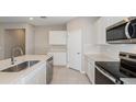 White kitchen with stainless steel appliances and quartz countertops at 8323 Sw 52Nd Lane Rd, Ocala, FL 34481