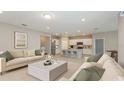 Bright, open-concept living room and kitchen with neutral tones and modern furnishings, perfect for entertaining at 8323 Sw 52Nd Lane Rd, Ocala, FL 34481