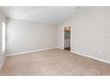 Carpeted bedroom offers a neutral color scheme, one window and an attached bathroom at 9569 Sw 62Nd Ct, Ocala, FL 34476
