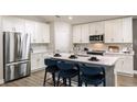Modern kitchen with stainless steel appliances, white cabinets, and an island at 6013 Sw 96Th Pl, Ocala, FL 34476