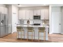 Bright kitchen features stainless steel appliances, modern white cabinetry, and quartz countertops at 6062 Sw 97Th St, Ocala, FL 34476