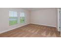 Bright bedroom offers plush carpeting, and windows providing a scenic outdoor view at 6074 Sw 97Th St, Ocala, FL 34476