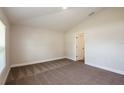 Spacious carpeted bedroom features natural light and neutral color palette at 6218 Sw 95Th Pl, Ocala, FL 34476