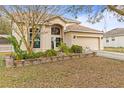 Charming two-story home with an attached two-car garage and a well-manicured front yard at 2644 W 75Th Blvd, Bushnell, FL 33513