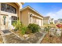 Inviting home entrance featuring decorative landscaping and a well-lit doorway at 2644 W 75Th Blvd, Bushnell, FL 33513