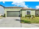 Lovely one-story home featuring a two-car garage and nicely landscaped front yard at 4310 Trotters Way, Lakeland, FL 33801