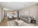 Open-concept living room featuring modern decor, wood floors, and seamless flow to the dining area at 5813 Sw 87Th Court Rd, Ocala, FL 34481