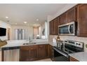 Modern kitchen with dark wood cabinets, stainless steel appliances, and quartz countertops at 8319 Sw 54Th Loop, Ocala, FL 34481