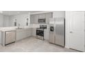 Modern kitchen featuring stainless steel appliances, gray cabinets, and stylish countertops at 8319 Sw 54Th Loop, Ocala, FL 34481