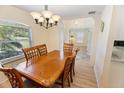 Dining room with chandelier lighting, wood table and views of the entrance at 4995 County Road 121D, Wildwood, FL 34785