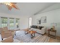 Bright living room featuring neutral tones, stylish furniture, and access to the backyard at 4995 County Road 121D, Wildwood, FL 34785
