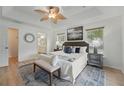 Serene main bedroom with tray ceilings, two windows, and ensuite bathroom at 4995 County Road 121D, Wildwood, FL 34785