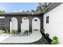 Modern entryway featuring arched entry and a stylish black and white design at 1309 Buccaneer Ave, Deltona, FL 32725