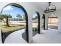 Elegant entryway with arched doorways, tile flooring, and a black chandelier at 1309 Buccaneer Ave, Deltona, FL 32725