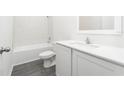 Clean bathroom with white tile and vanity at 13454 Leaping Water Way, Astatula, FL 34705