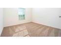 Simple bedroom with neutral carpet and a window at 13454 Leaping Water Way, Astatula, FL 34705