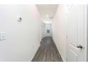 Bright hallway with wood-look flooring and neutral walls at 13481 Leaping Water Way, Astatula, FL 34705