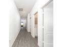 Bright hallway with wood-look floors and access to other rooms at 13481 Leaping Water Way, Astatula, FL 34705