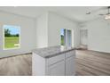 Bright, open-concept living room features wood floors and sliding glass doors to the backyard at 13489 Leaping Water Way, Astatula, FL 34705