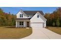 Charming two-story farmhouse-style home with a two-car garage and well-kept lawn at 2468 Fawn Run, Oviedo, FL 32765