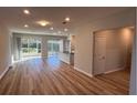 Open living room with vinyl plank flooring and sliding doors to a lanai at 9114 Sw 65Th Loop, Ocala, FL 34481