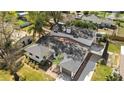 Aerial view of a home with a black roof, nice lawn, and long driveway at 3203 S Polk Ave, Lakeland, FL 33803