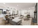 Bright open-concept living room featuring a fireplace, modern furnishings and decor, and an eat-in kitchen at 3203 S Polk Ave, Lakeland, FL 33803