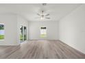 Bright living room features wood-look flooring and modern ceiling fan at 13466 Leaping Water Way, Astatula, FL 34705