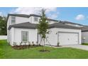 Beautiful two-story home featuring manicured lawn and a gray and white color scheme at 13477 Leaping Water Way, Astatula, FL 34705