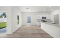 Open kitchen area with granite countertops and modern finishes at 13477 Leaping Water Way, Astatula, FL 34705
