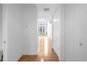 Hallway with wood floors leads to a brightly lit living area, creating an inviting atmosphere at 150 E Robinson St # 221, Orlando, FL 32801