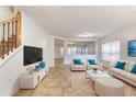 Living room with beige sofas, a coffee table, and a large TV at 2804 Polson Dr, Kissimmee, FL 34758