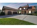 Two-story house with three car garage and terracotta tile roof at 2024 Capri Ln, Mount Dora, FL 32757