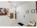 Interior entryway with built-in bench, shelves, and white door at 7614 Oak Spring Ln, Davenport, FL 33837