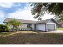 Updated home with gray garage door and palm trees at 7631 Lewis Rd, Lakeland, FL 33810