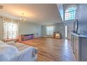 Bright living room featuring an open floor plan, wood floors, and a large window for natural light at 169 Vista View Ave, Eagle Lake, FL 33839
