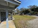 Sunny view of front yard with grass leading to a split rail fence at 1224 10Th St, Holly Hill, FL 32117