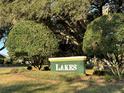 Community sign amid lush landscaping, welcoming residents and visitors to the Lakes neighborhood at 17729 Se 114Th Ct, Summerfield, FL 34491