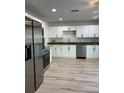 Updated kitchen featuring stainless steel appliances and granite countertops, perfect for cooking at 17729 Se 114Th Ct, Summerfield, FL 34491